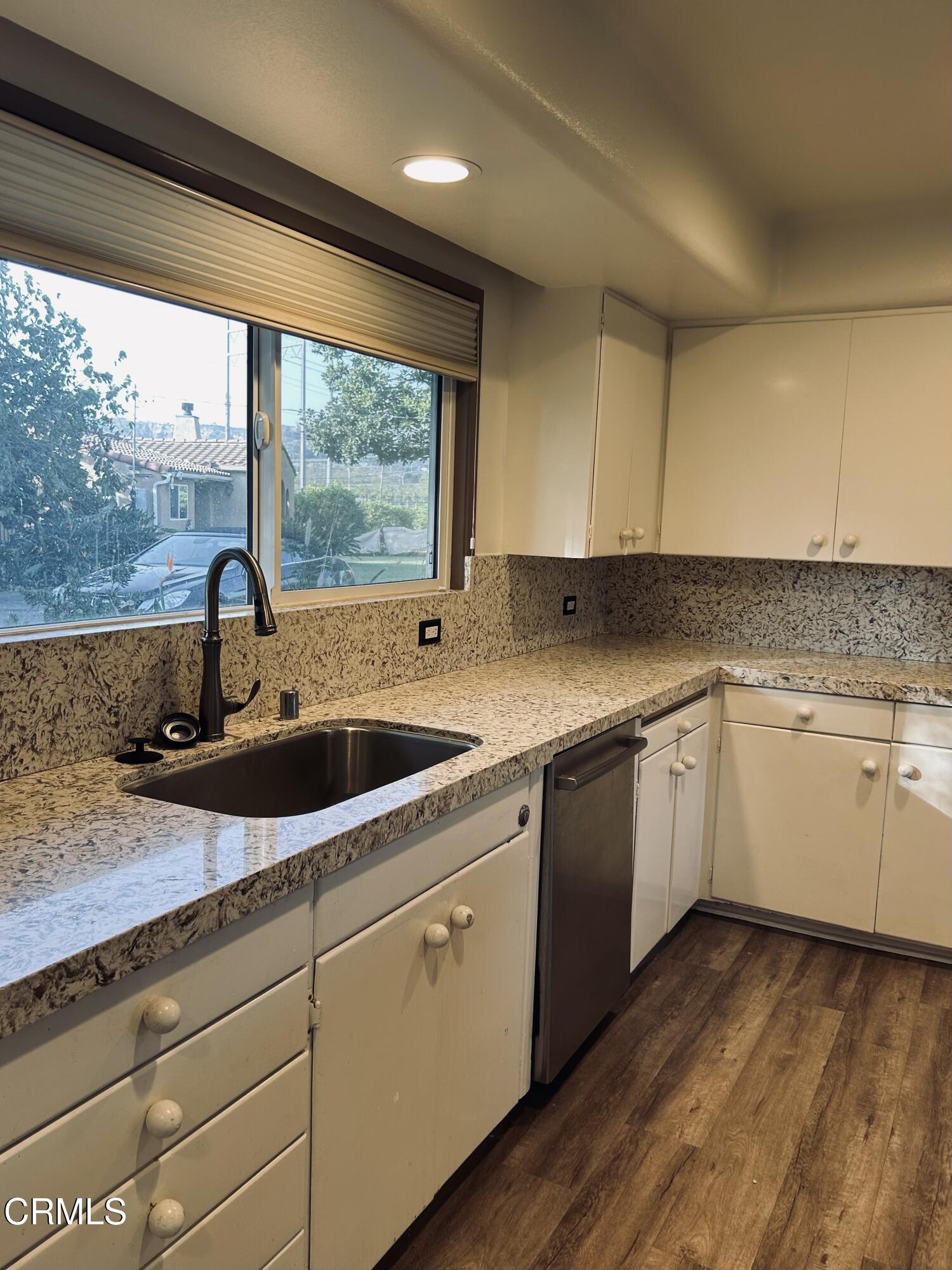 9630 Santa Rosa Road Camarillo, CA 93012 - Photo 13 of 35 a kitchen with a sink window and cabinets