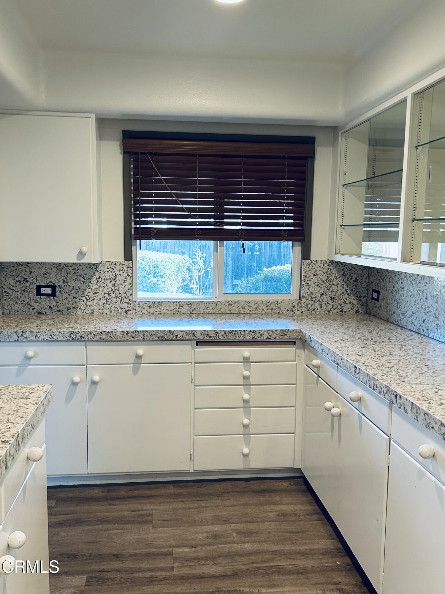 9630 Santa Rosa Road Camarillo, CA 93012 - Photo 14 of 35 a kitchen with granite countertop white cabinets and a window