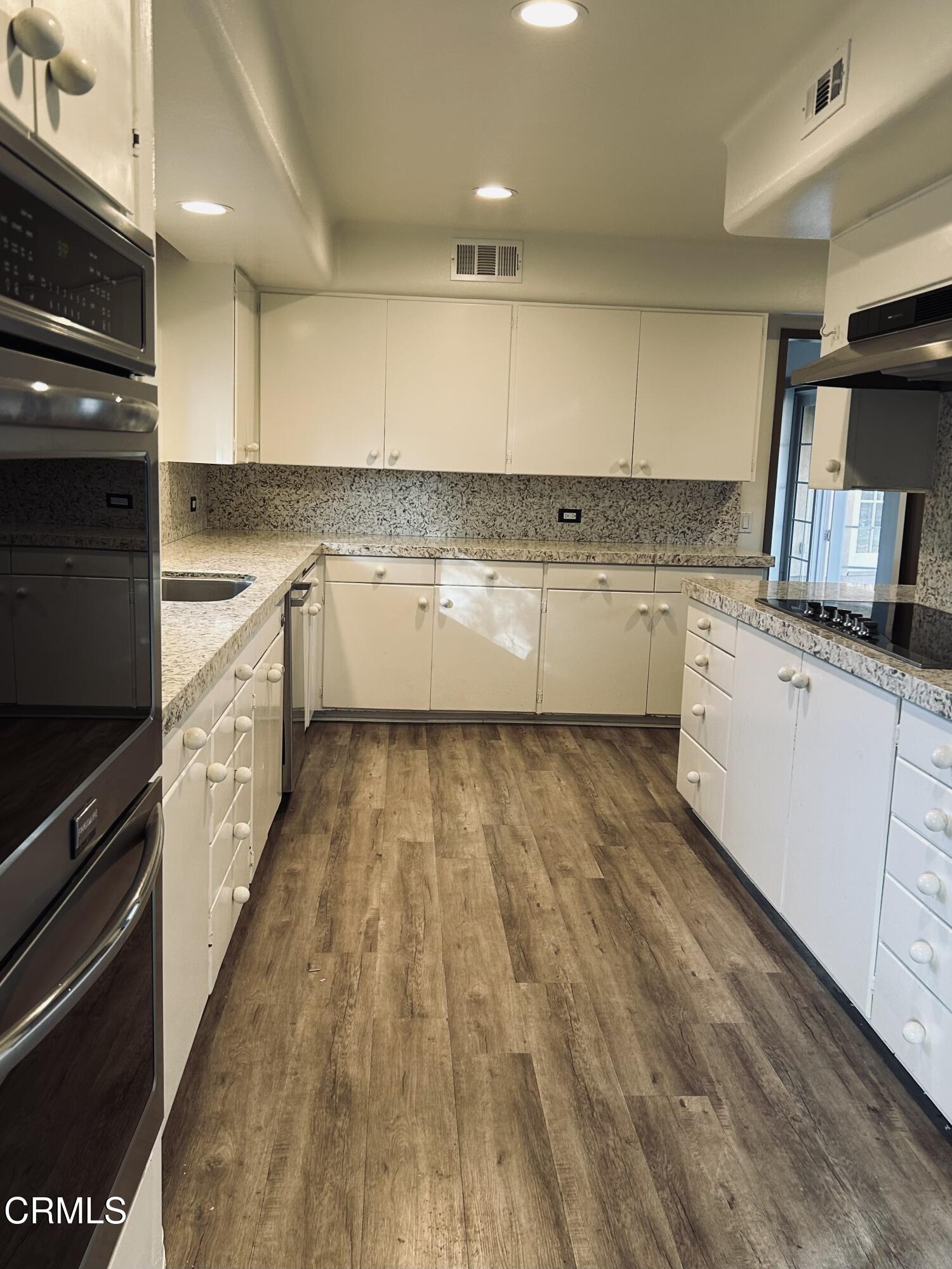 9630 Santa Rosa Road Camarillo, CA 93012 - Photo 18 of 35 a large kitchen with granite countertop a stove top oven a sink a counter space and cabinets