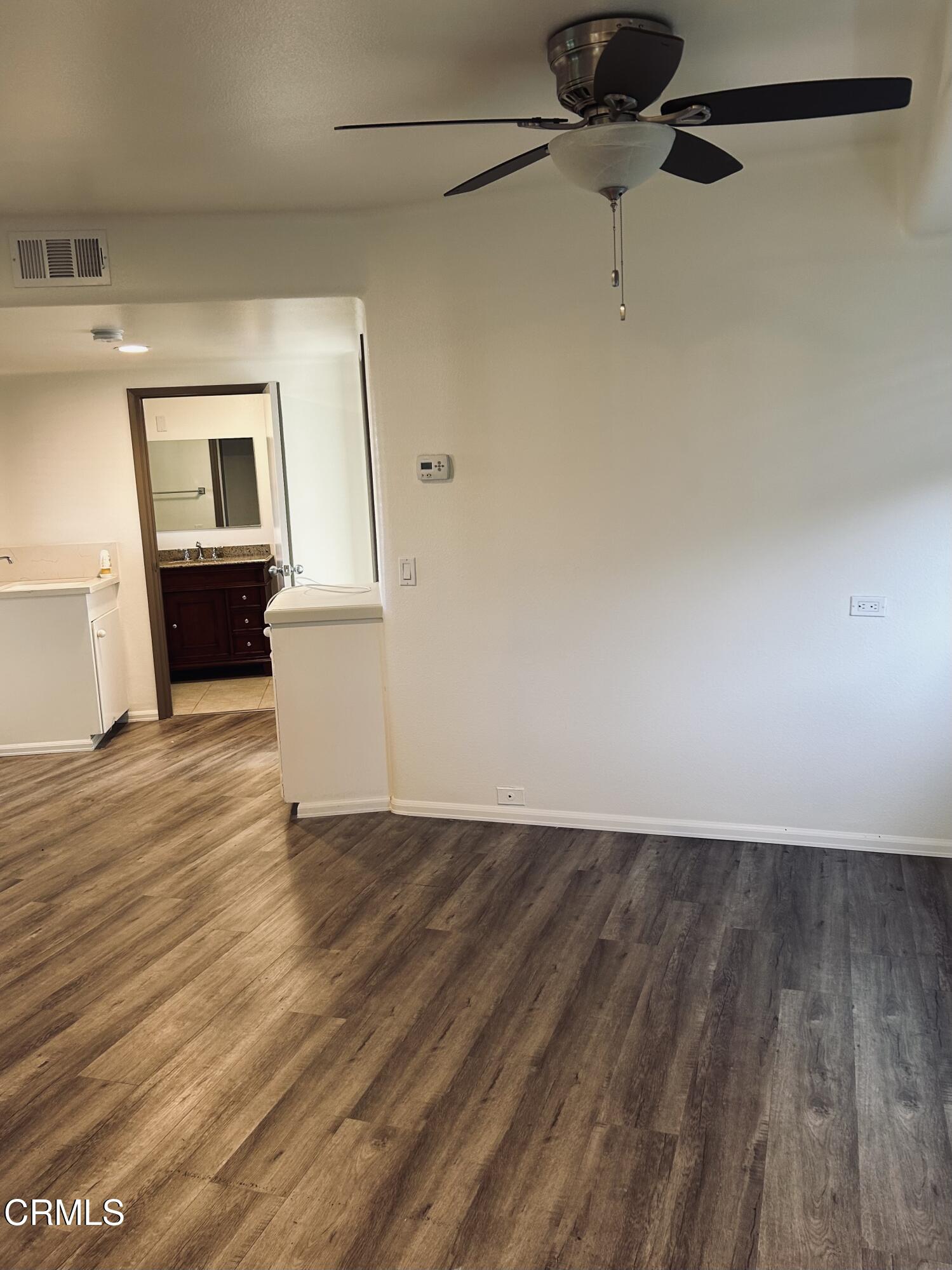 9630 Santa Rosa Road Camarillo, CA 93012 - Photo 6 of 35 a view of a livingroom with wooden floor and cabinet
