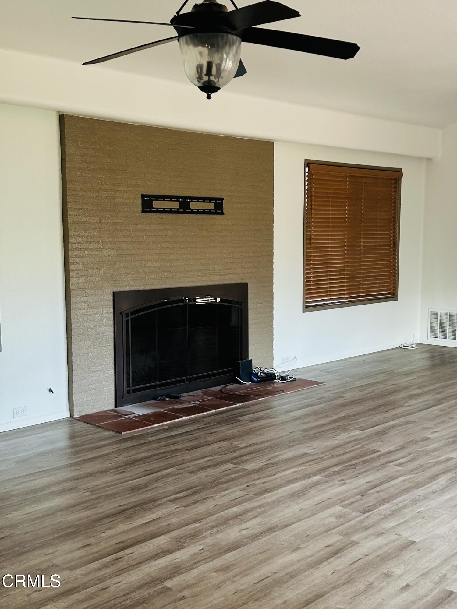 9630 Santa Rosa Road Camarillo, CA 93012 - Photo 7 of 35 a view of an empty room with wooden floor and a fireplace