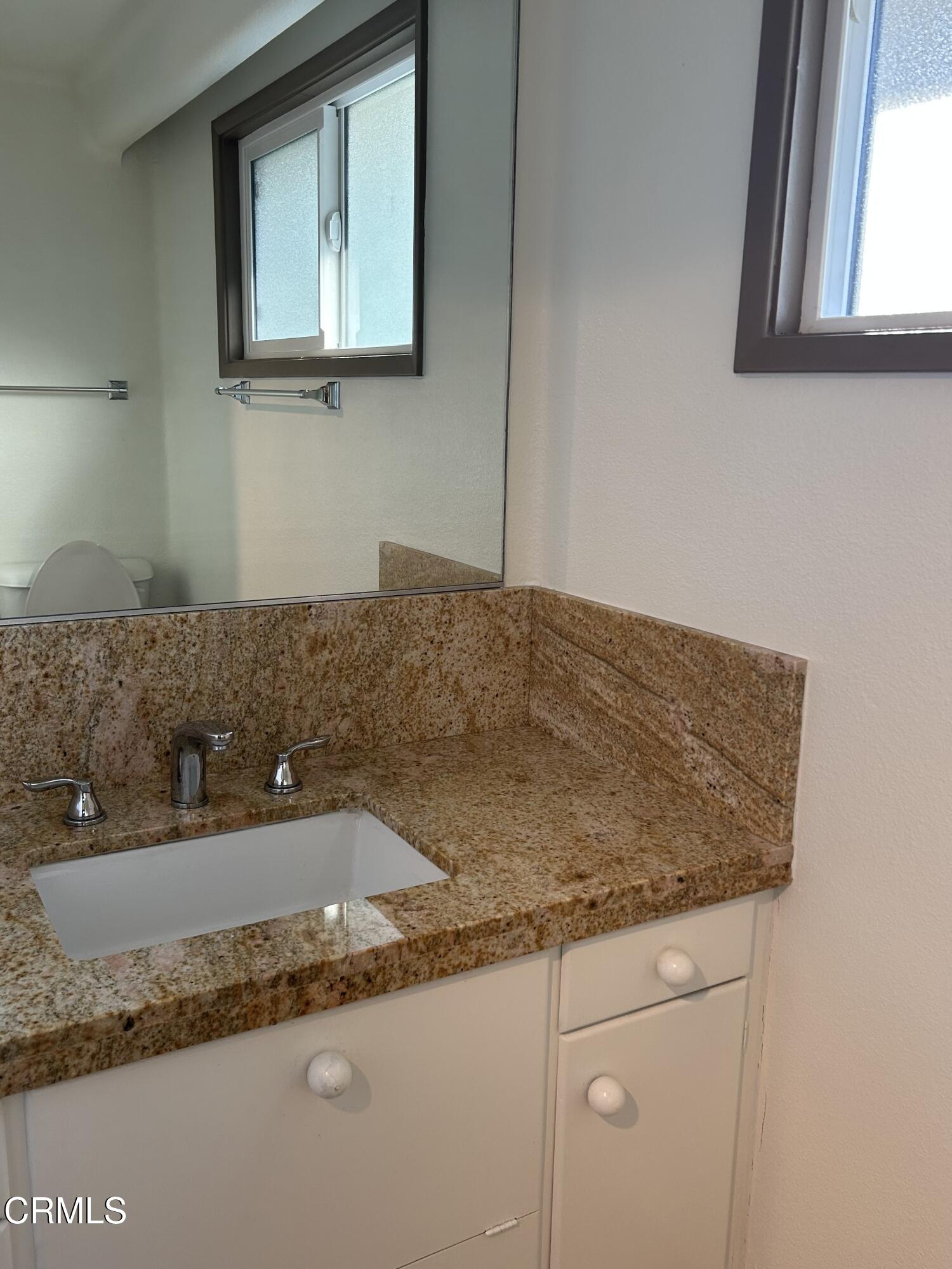 9630 Santa Rosa Road Camarillo, CA 93012 - Photo 8 of 35 a bathroom with a granite countertop sink and a mirror