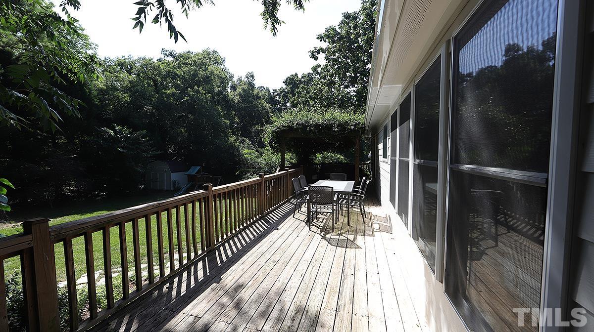 3016 Old Orchard Road Raleigh, NC 27607 - Photo 34 of 39 a balcony with wooden floor table and chairs