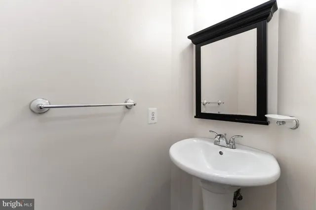 a bathroom with a sink a mirror and a toilet