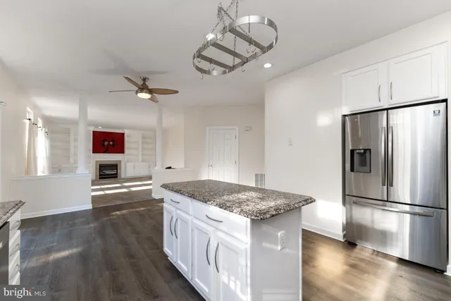 a kitchen with stainless steel appliances granite countertop a sink refrigerator and microwave