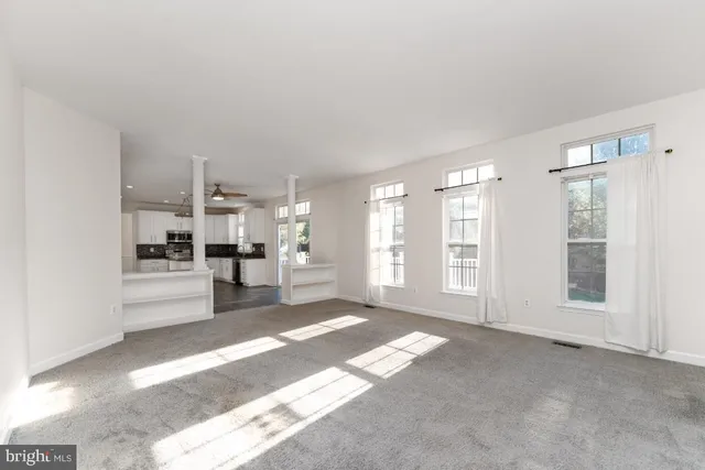 a view of a big room with windows and cabinet