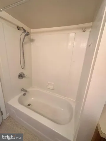 a bathroom with a shower and a bath tub