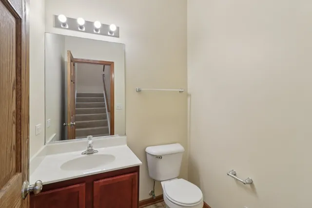 a bathroom with a sink a toilet and mirror