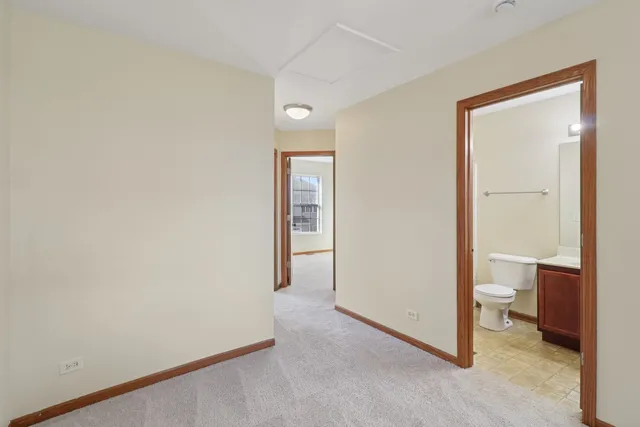 a view of a room with wooden floor cabinet and a bathroom