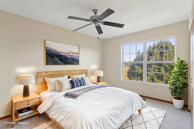 a bedroom with a large bed and a potted plant