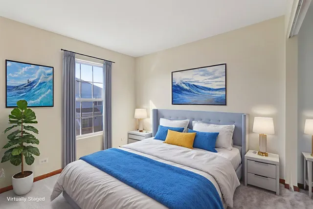 a bedroom with a large bed and a potted plant