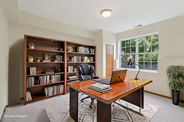 a view of a workspace with a bookshelf