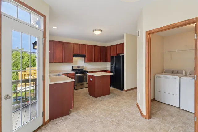 a kitchen with a refrigerator and a stove top oven