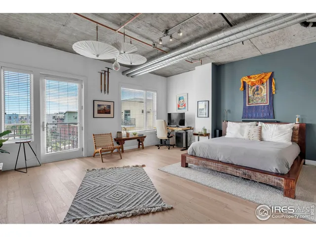 a spacious bedroom with a bed a couch and a table