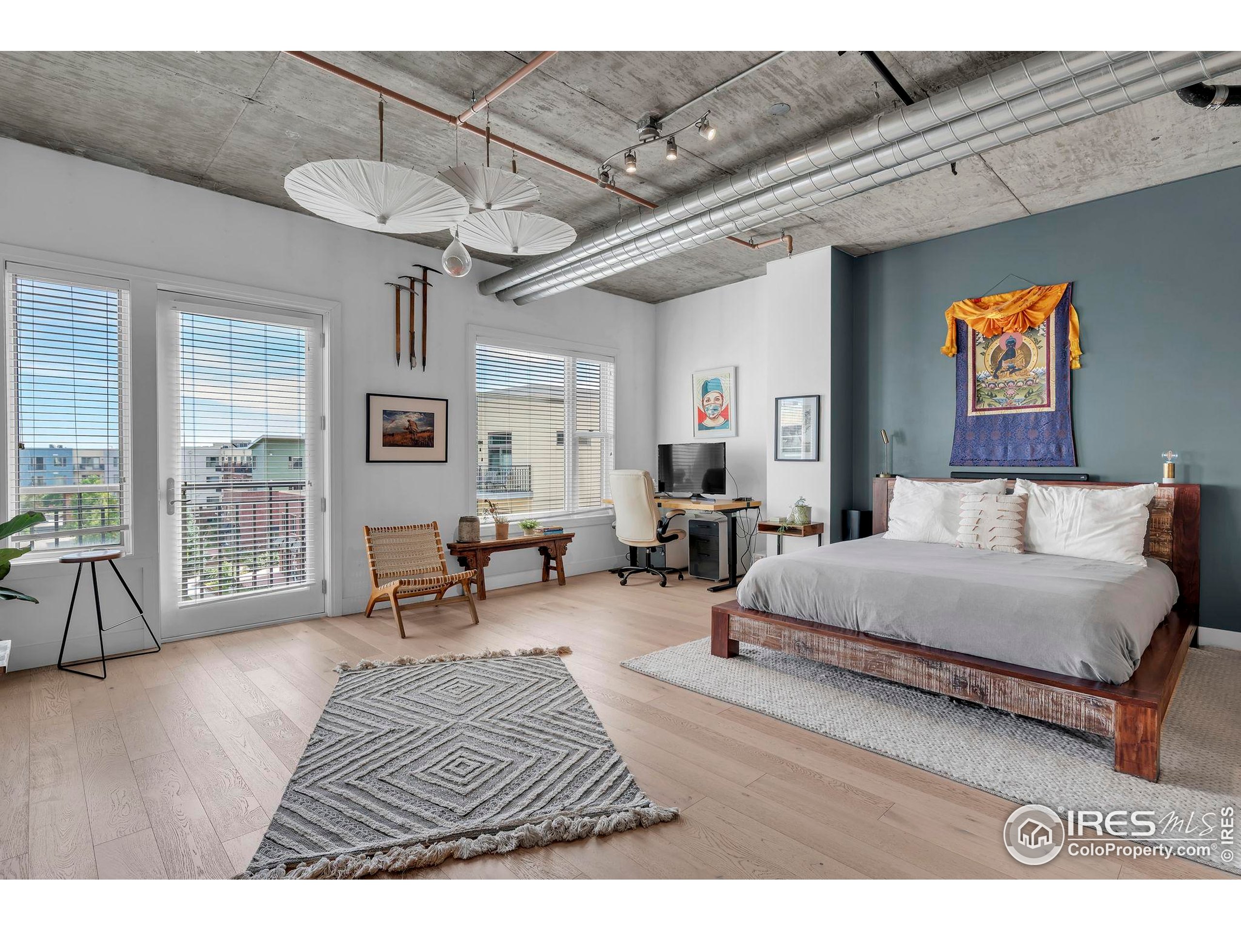 3301 Arapahoe Avenue, Unit 405 Boulder, CO 80303 - Photo 1 of 36 a spacious bedroom with a bed a couch and a table