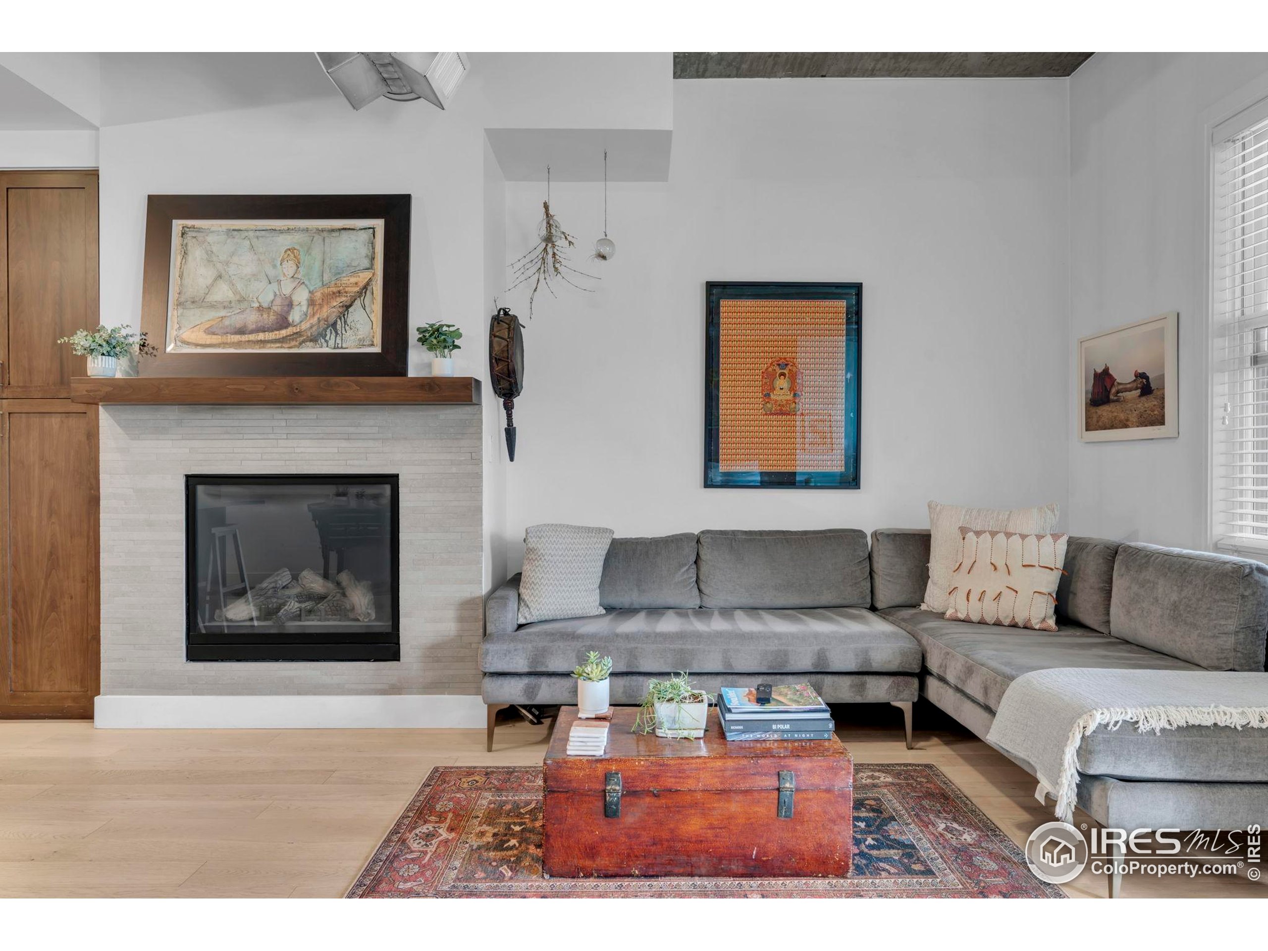 3301 Arapahoe Avenue, Unit 405 Boulder, CO 80303 - Photo 2 of 36 a living room with furniture and a fireplace