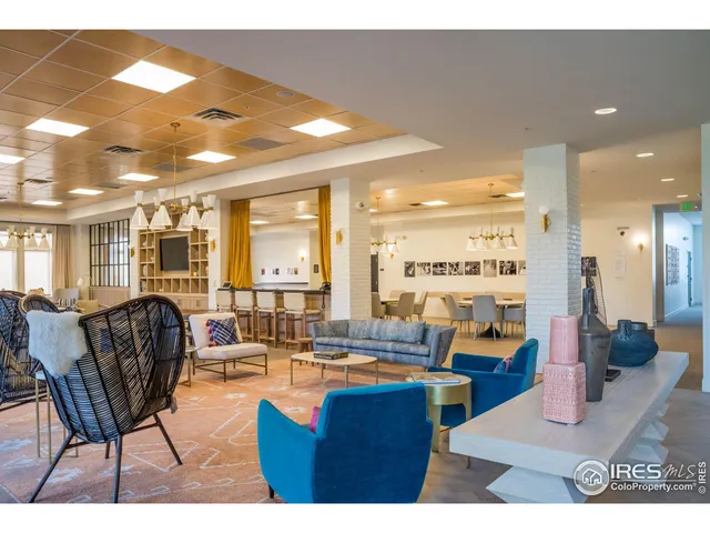 a living room with furniture a rug and a chandelier
