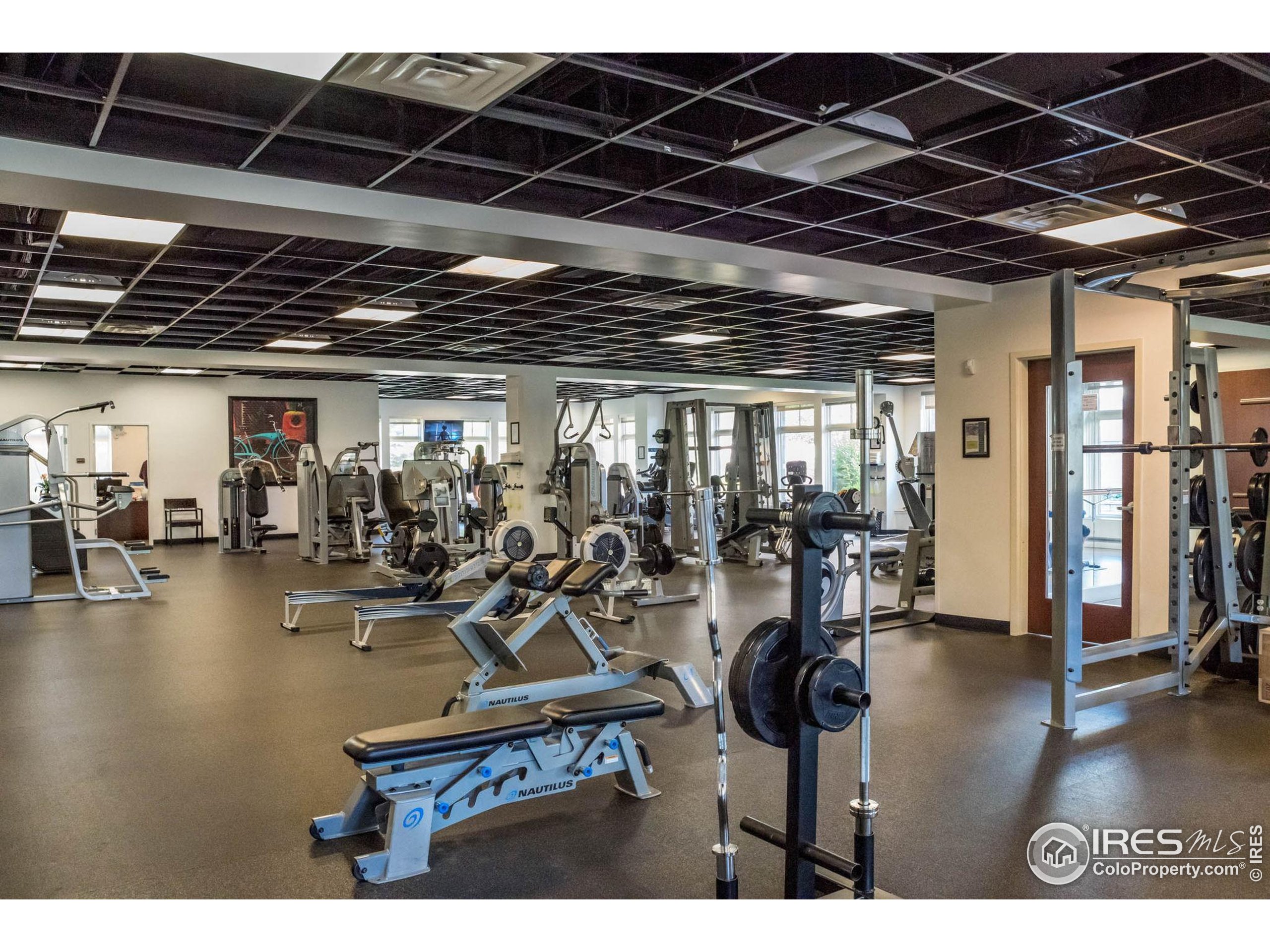 3301 Arapahoe Avenue, Unit 405 Boulder, CO 80303 - Photo 23 of 36 a view of a room with gym equipment