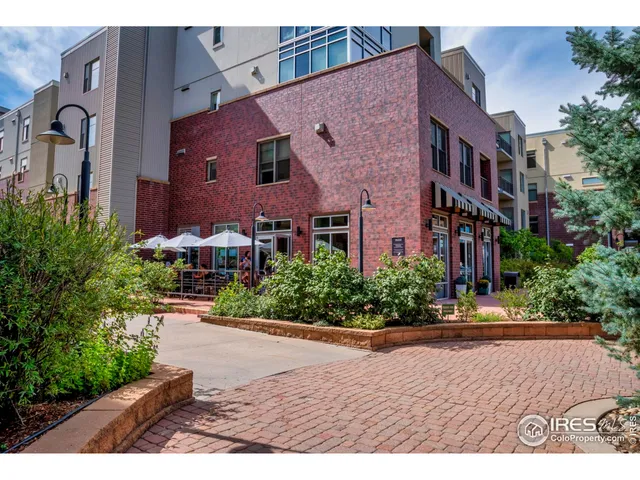 a view of a brick building next to a yard