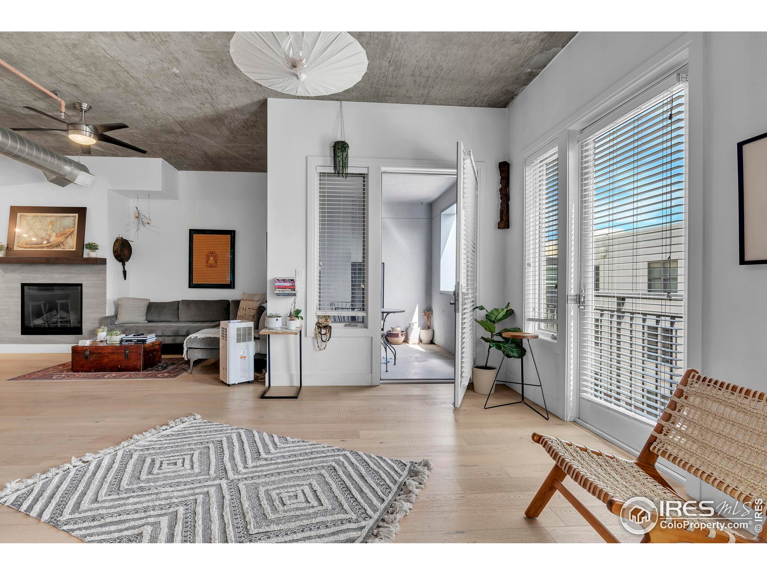 3301 Arapahoe Avenue, Unit 405 Boulder, CO 80303 - Photo 4 of 36 a bedroom with furniture and a fireplace