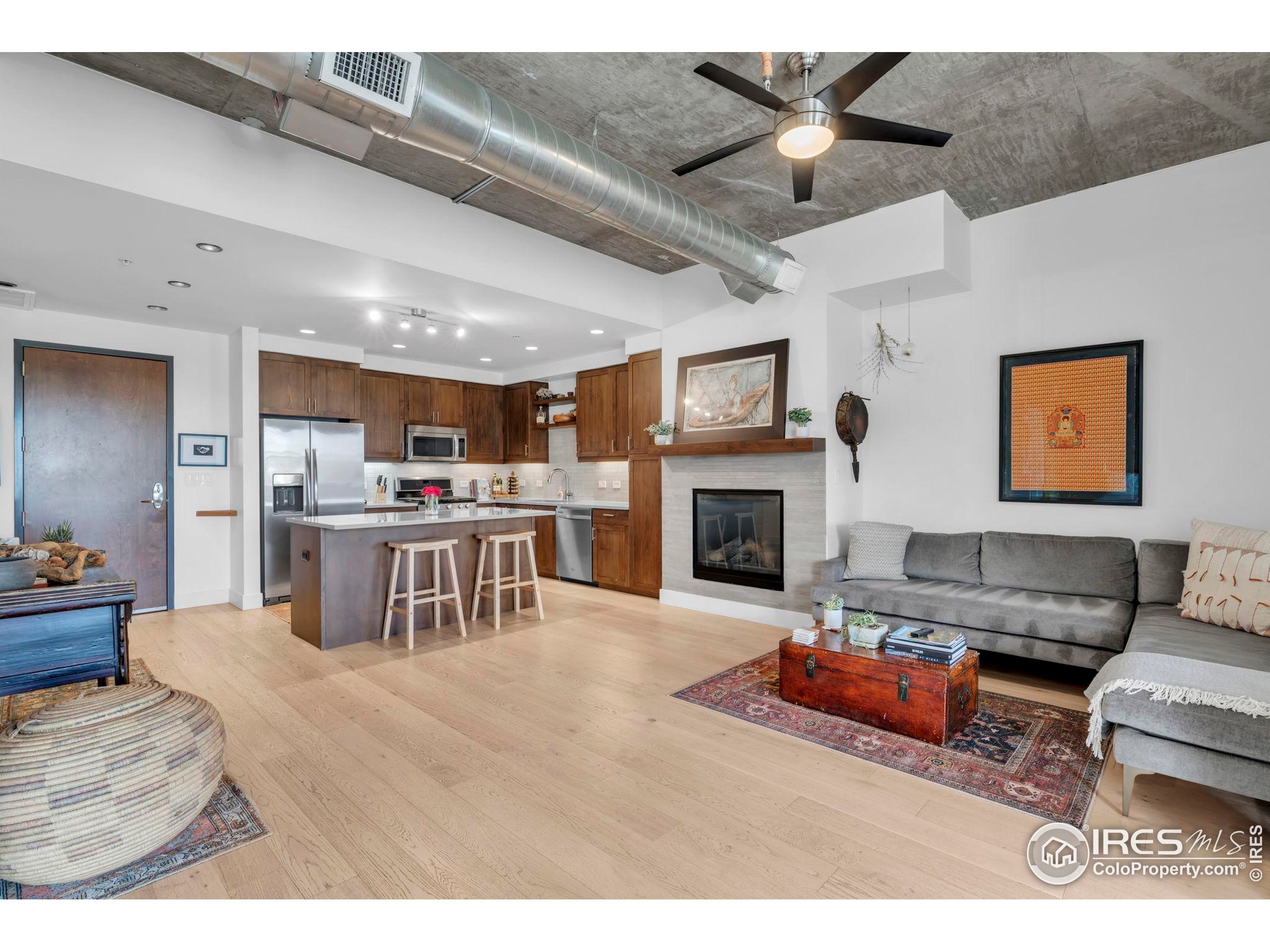 3301 Arapahoe Avenue, Unit 405 Boulder, CO 80303 - Photo 8 of 36 a living room with furniture and a fireplace