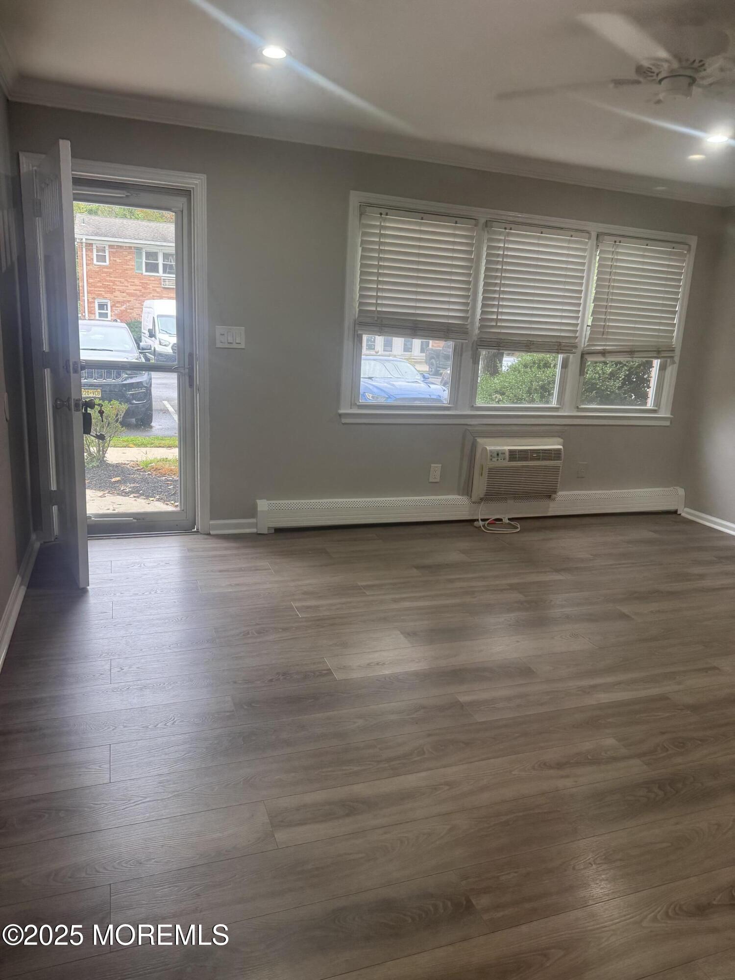 a view of room with window and wooden floor