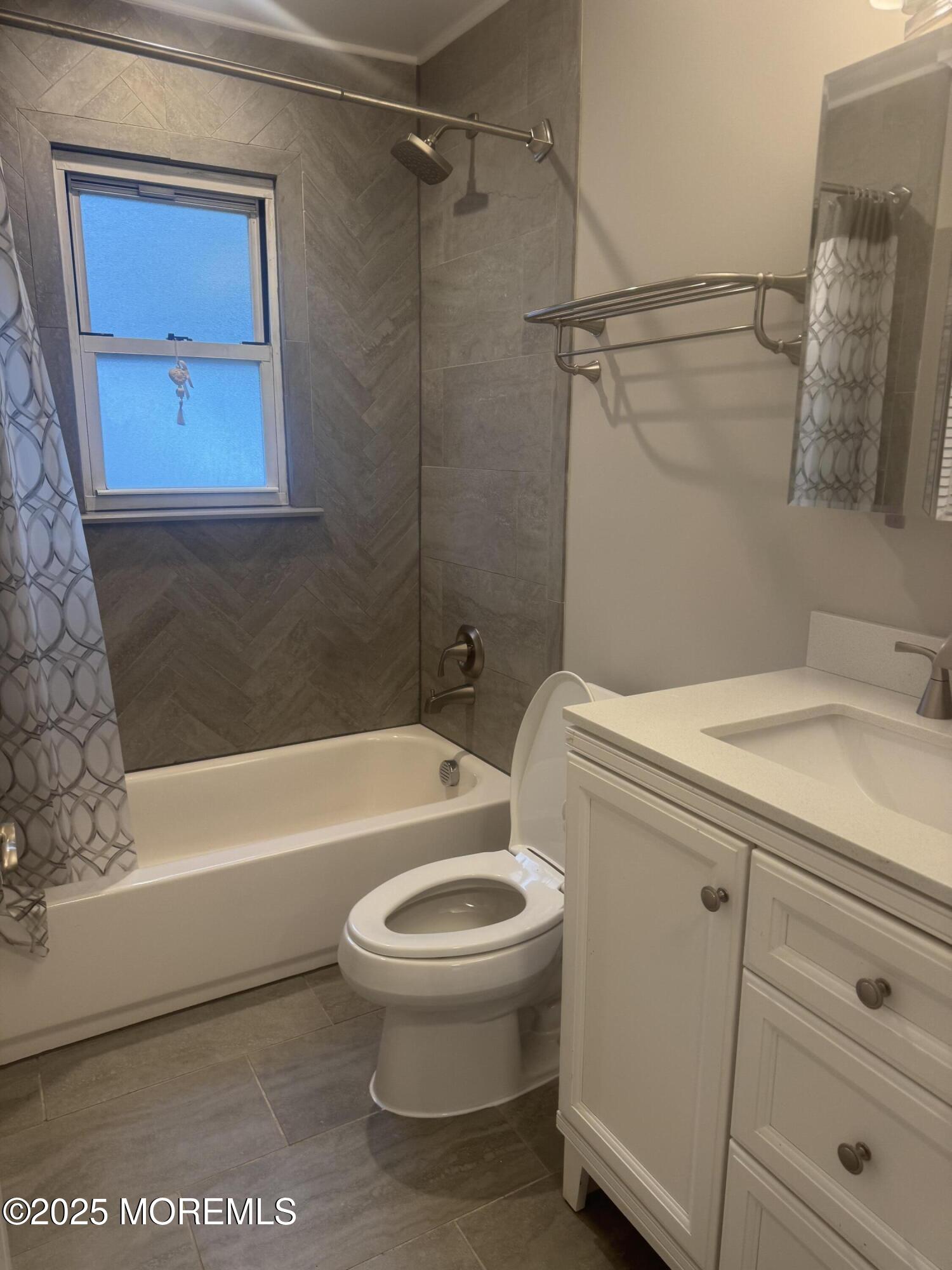 96 East Avenue, Unit 65 Atlantic Highlands, NJ 07716 - Photo 11 of 13 a bathroom with a sink a toilet and bathtub
