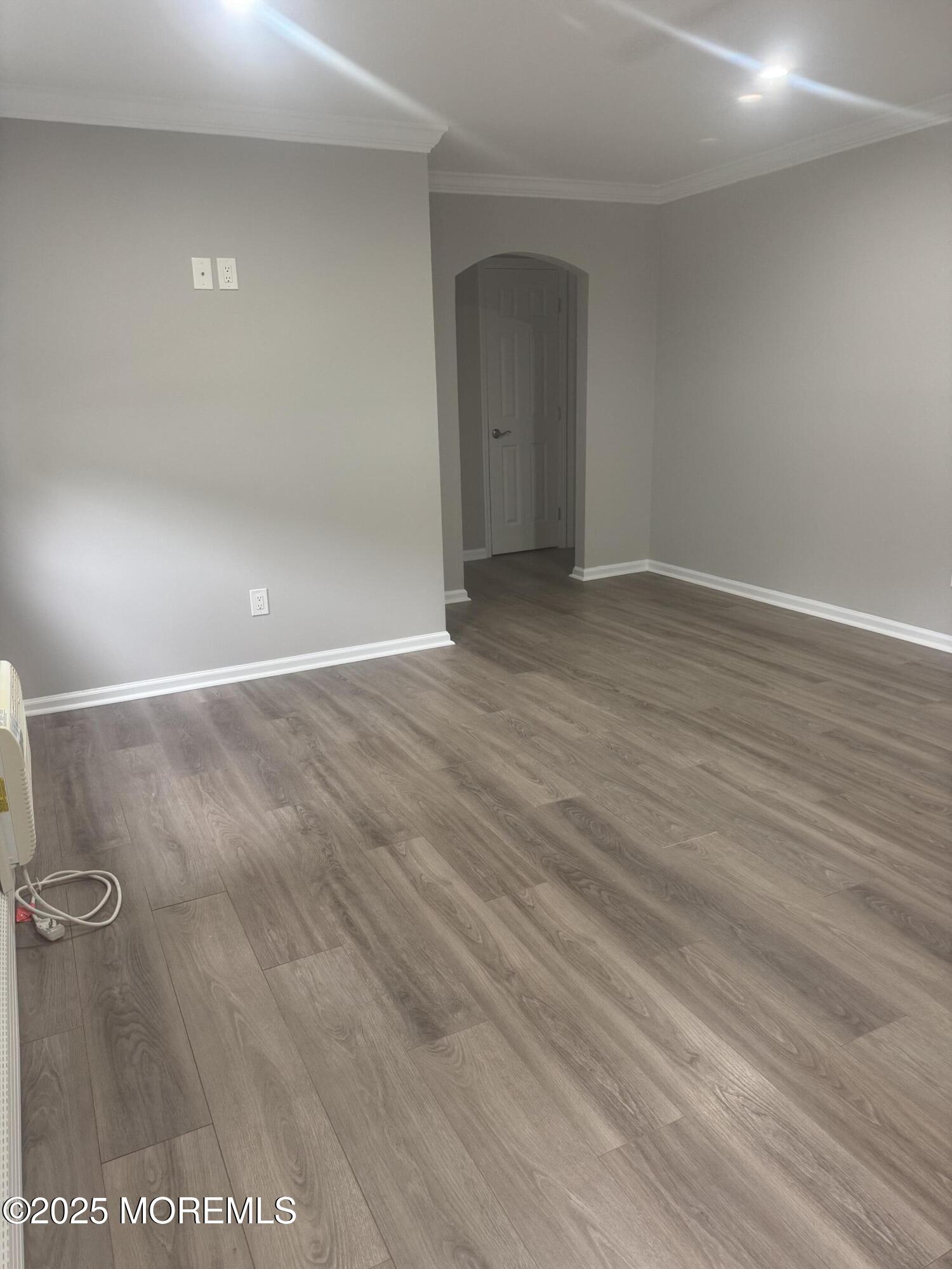 96 East Avenue, Unit 65 Atlantic Highlands, NJ 07716 - Photo 2 of 13 a view of an empty room with wooden floor and a window