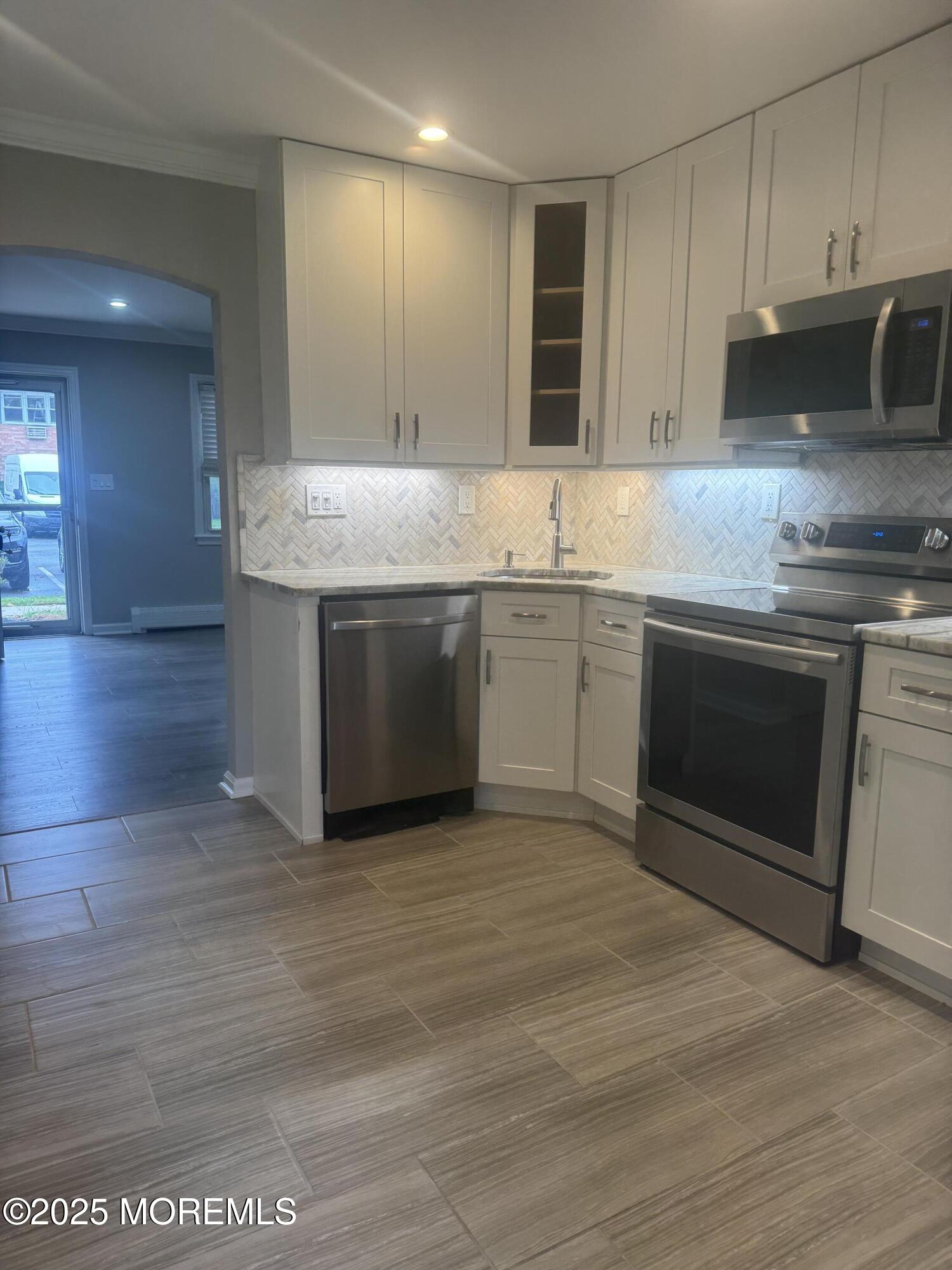 96 East Avenue, Unit 65 Atlantic Highlands, NJ 07716 - Photo 3 of 13 a kitchen with a sink cabinets and stainless steel appliances