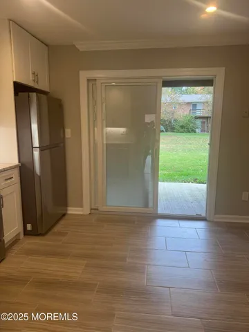 a view of an empty room with a fireplace and a window