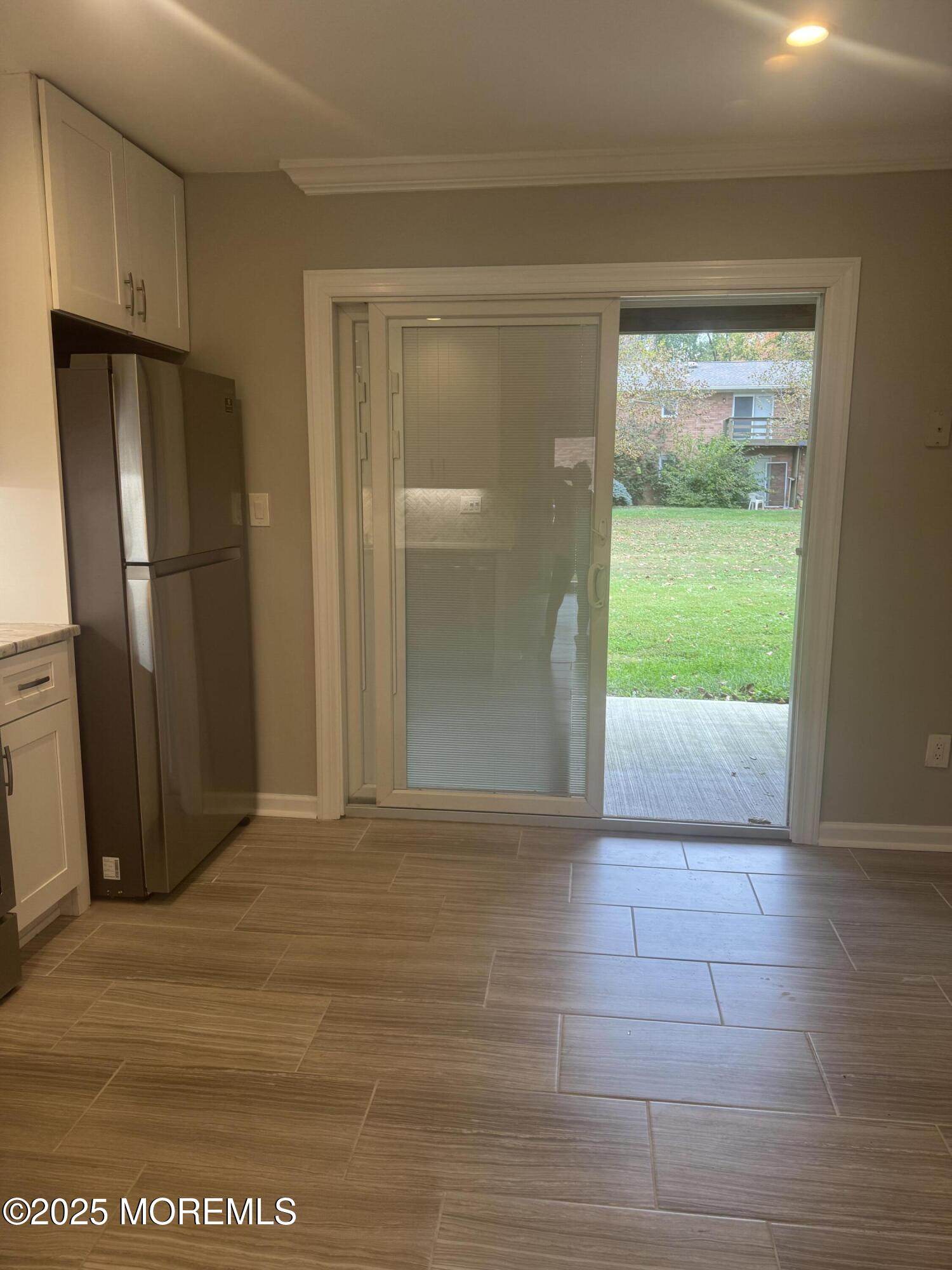 96 East Avenue, Unit 65 Atlantic Highlands, NJ 07716 - Photo 4 of 13 a view of an empty room with a fireplace and a window