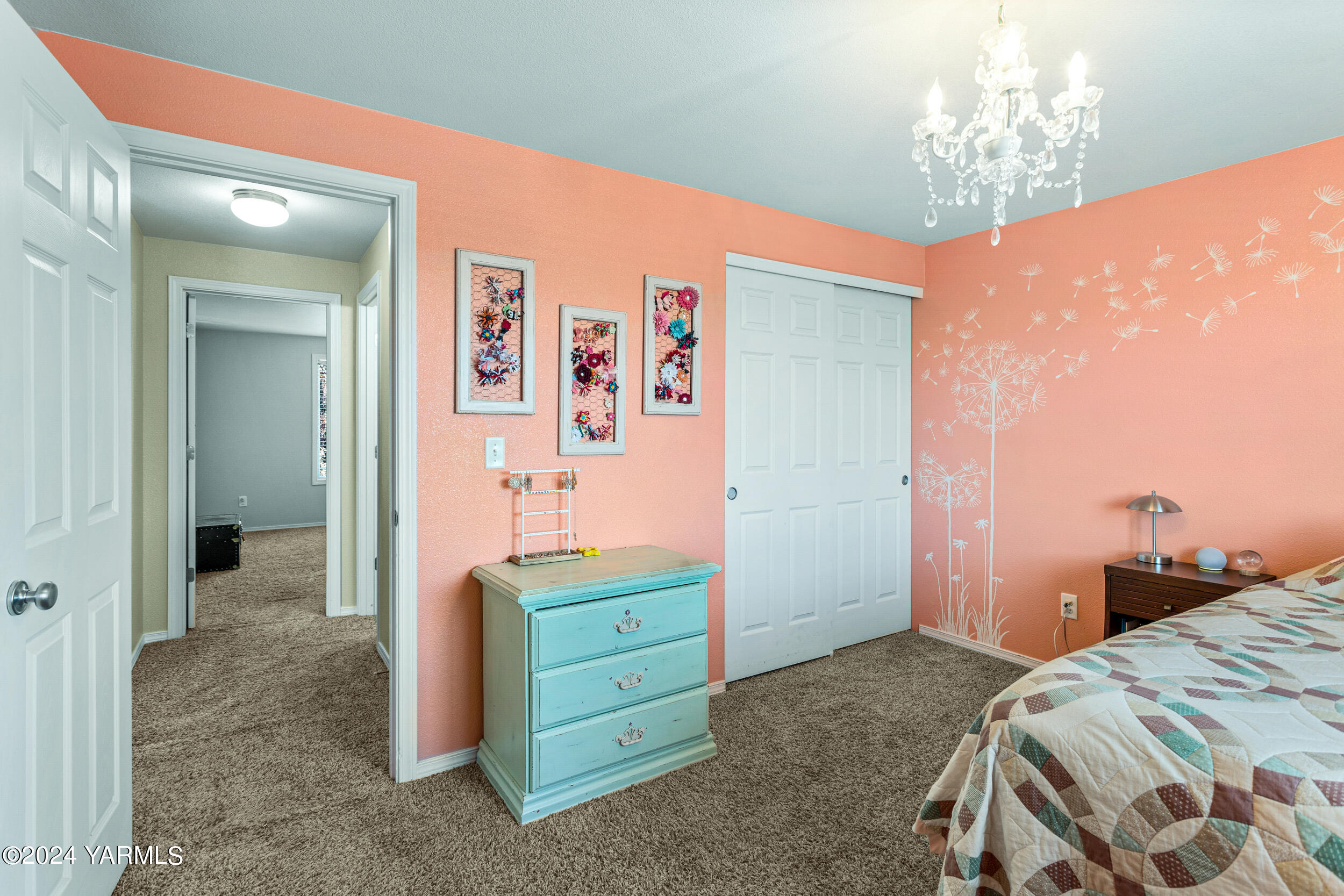 810 Millenium Avenue Moxee, WA 98936 - Photo 30 of 38 a bedroom with a bed and a chandelier