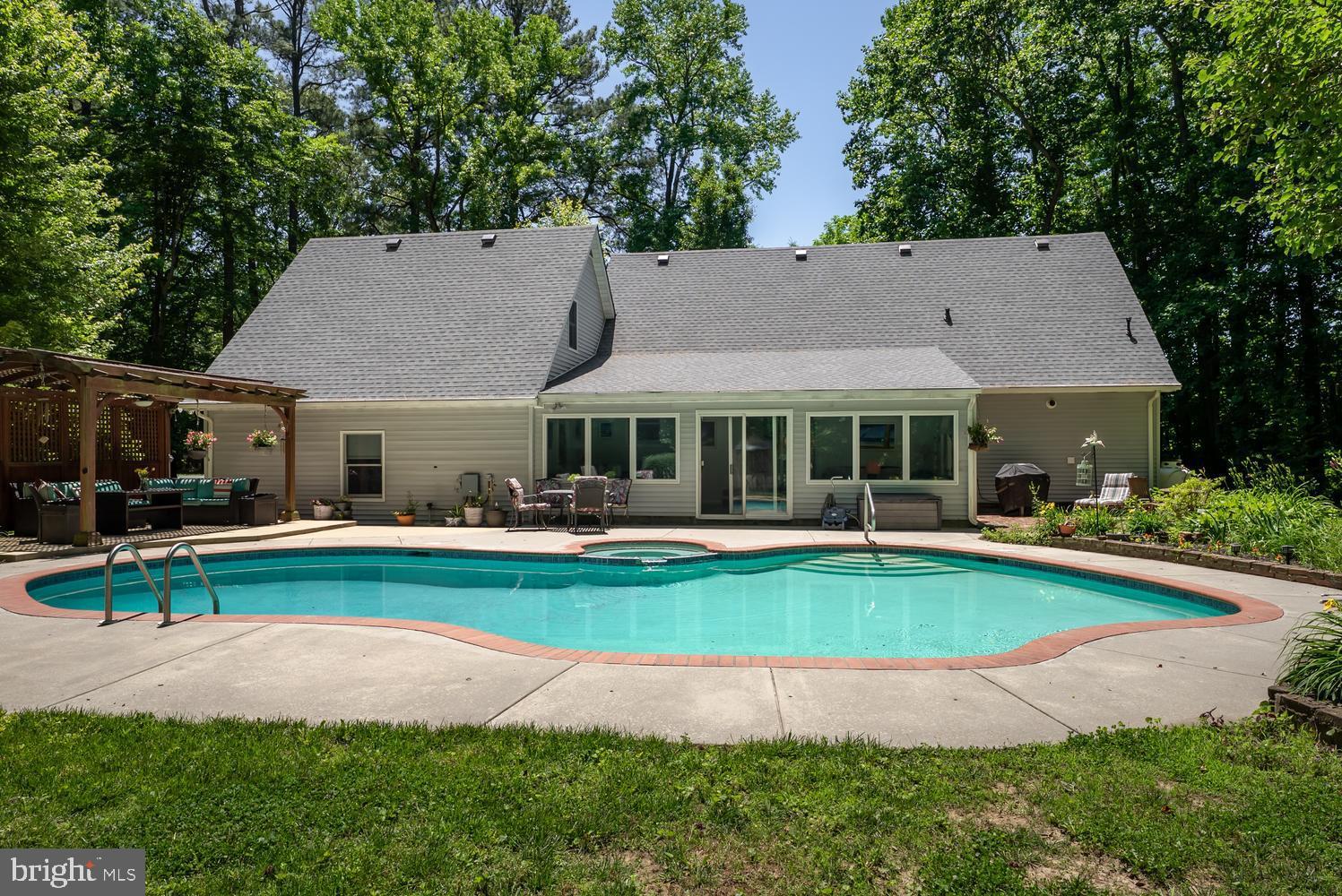 814 Wrights Neck Road Centreville, MD 21617 - Photo 10 of 53 a front view of a house with swimming pool having outdoor seating