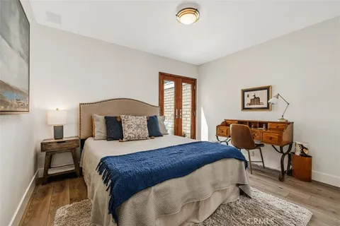 a bathroom with a toilet a sink a mirror a bathtub and shower