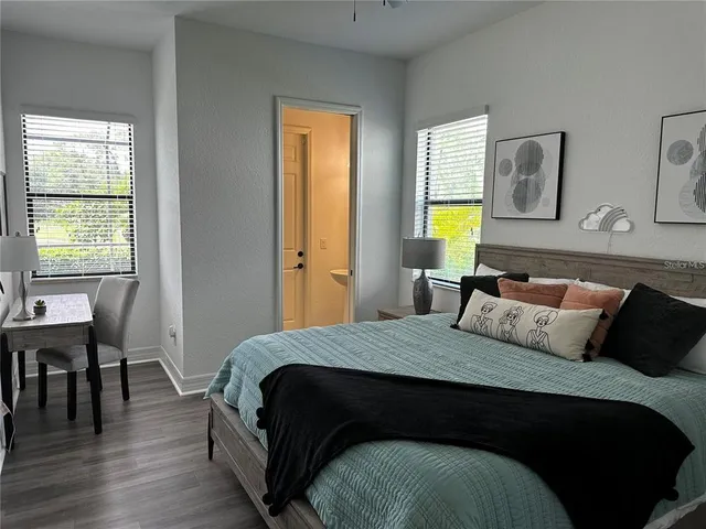 a bedroom with a bed and a table in it