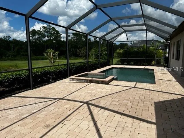 a view of a swimming pool with a patio