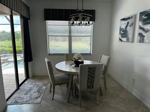 a dining room with furniture and window