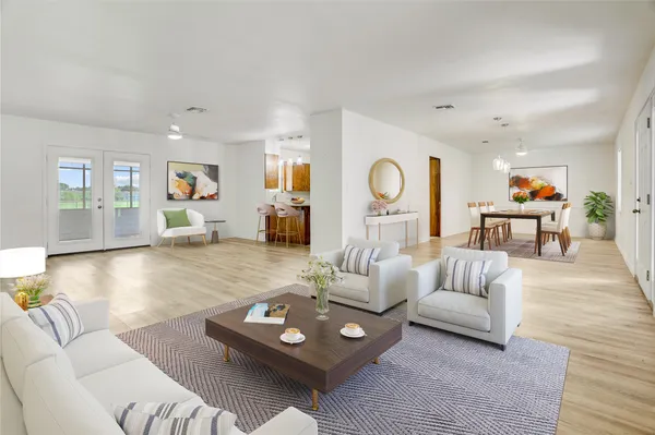 a living room with furniture and wooden floor