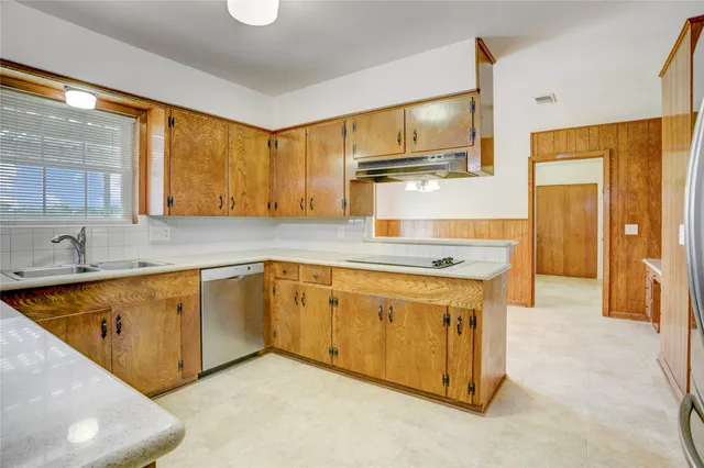 a kitchen with stainless steel appliances granite countertop a sink and cabinets