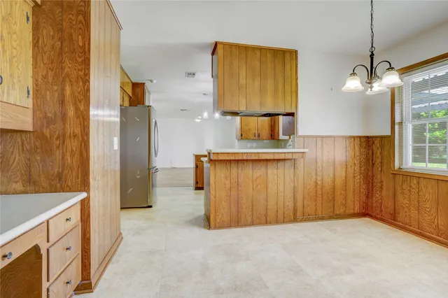 a view of a kitchen and a sink cabinet mirror and a window