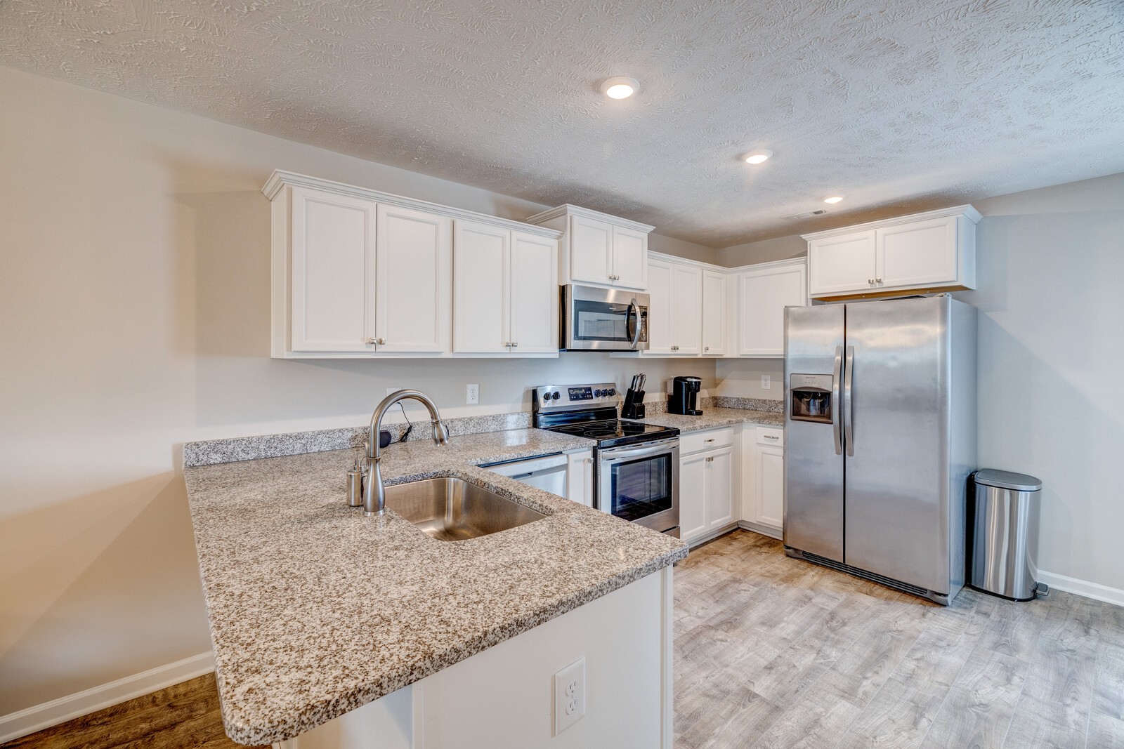 3406 Learning Lane Murfreesboro, TN 37128 - Photo 13 of 32 a kitchen with granite countertop a refrigerator a sink a stove a microwave and island