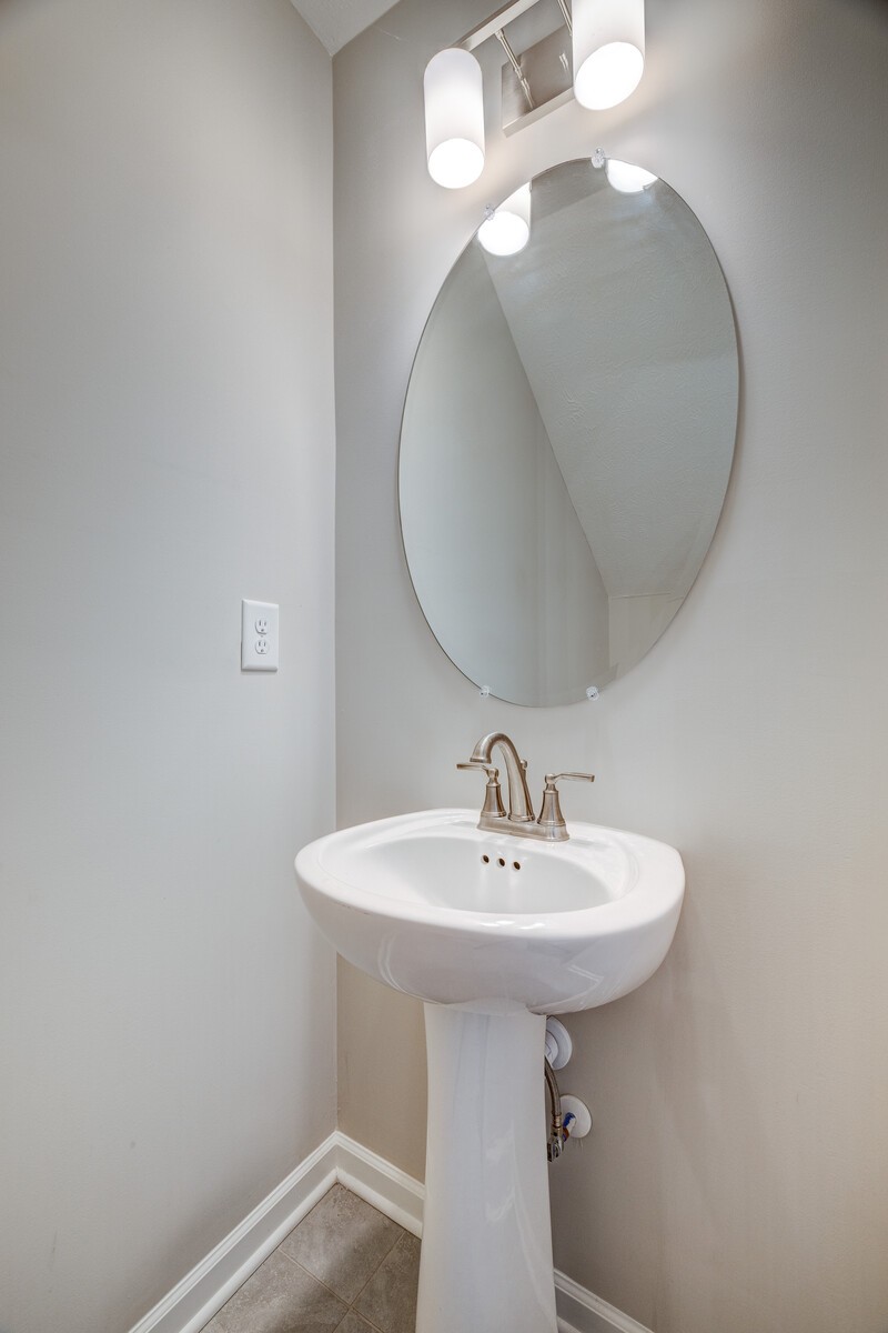 3406 Learning Lane Murfreesboro, TN 37128 - Photo 15 of 32 a bathroom with a sink a mirror and lamp