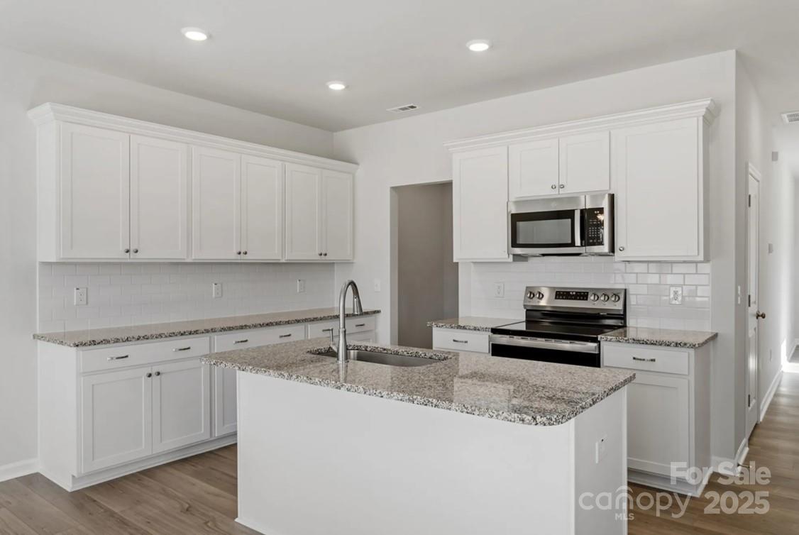 2712 Lehigh Road Charlotte, NC 28208 - Photo 2 of 7 a kitchen with appliances a sink and cabinets
