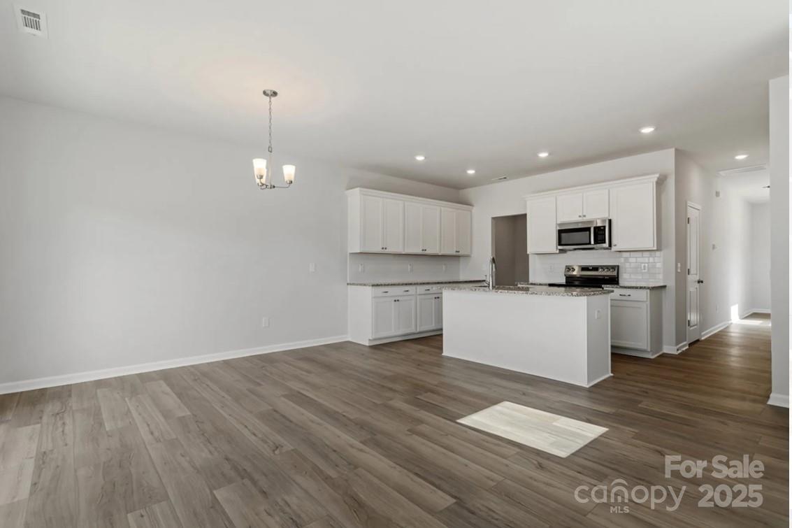 2712 Lehigh Road Charlotte, NC 28208 - Photo 4 of 7 a kitchen with stainless steel appliances granite countertop a stove a sink and a refrigerator