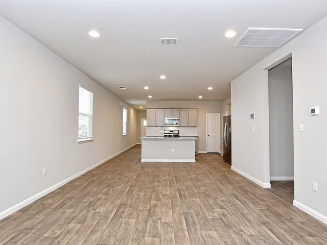 a view of kitchen with refrigerator and window