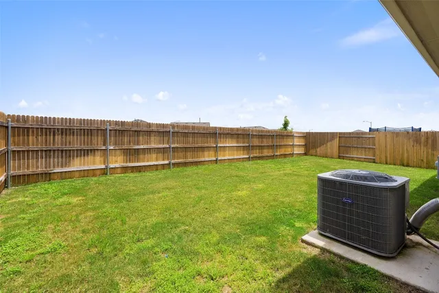 a view of a house with a backyard and a small yard