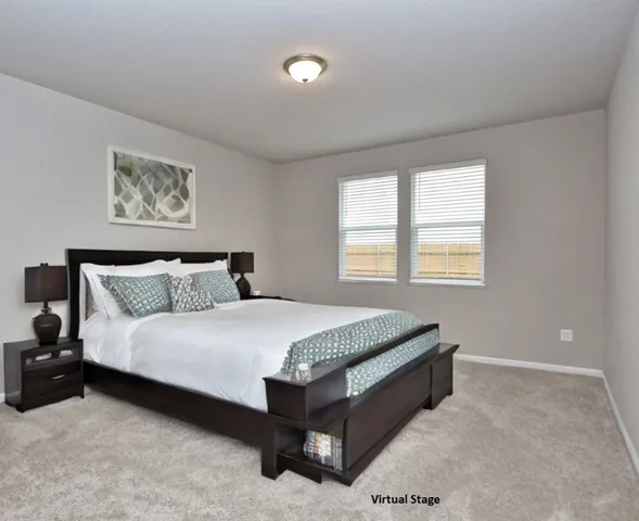 a spacious bedroom with a bed and window