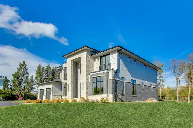 a front view of house with yard and green space