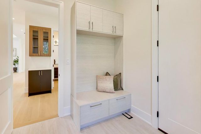 a view of an empty room with a cabinet and a window