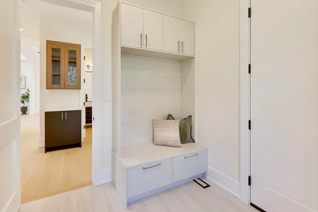 a view of an empty room with a cabinet and a window